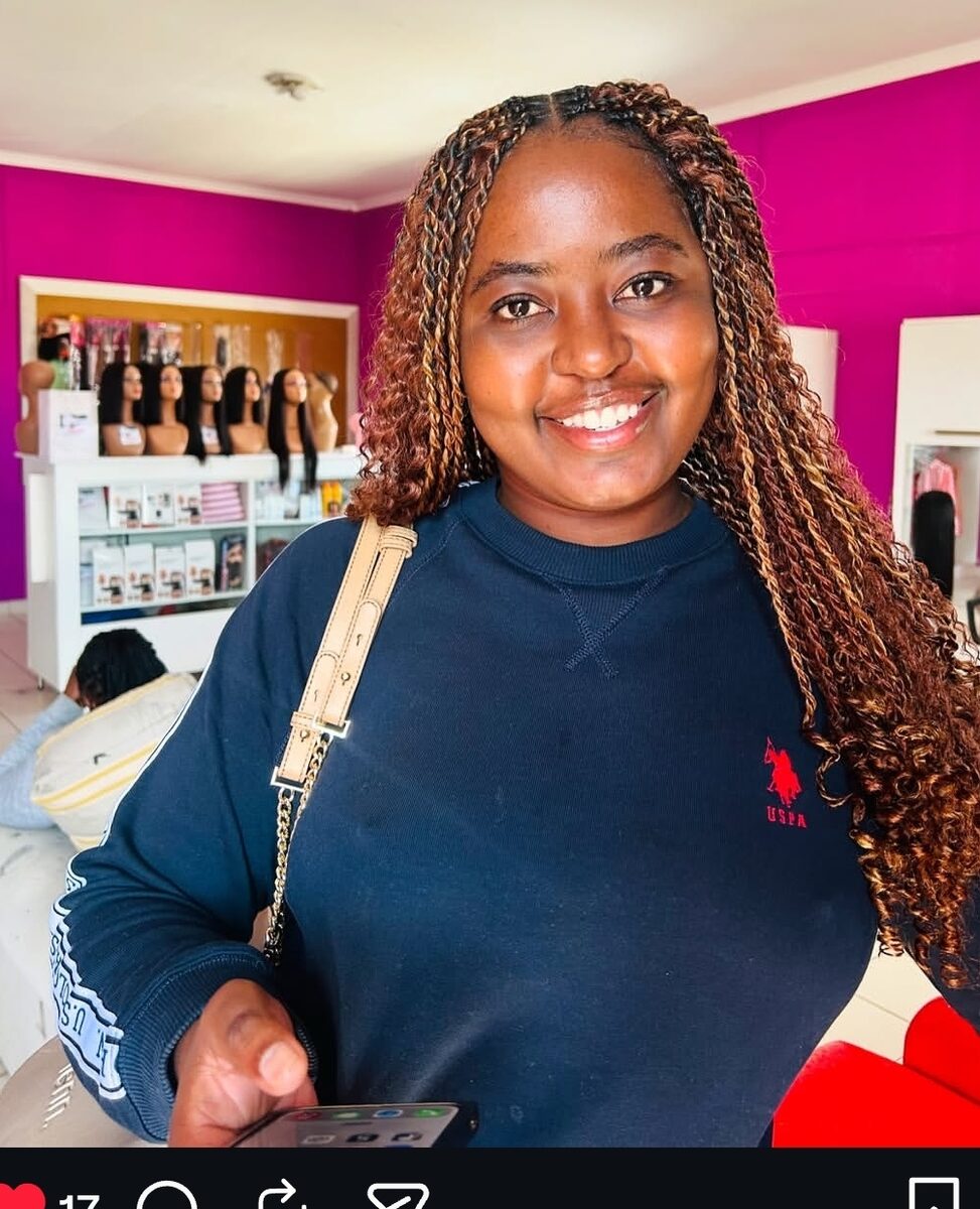 Smiling client with brown and blonde braids